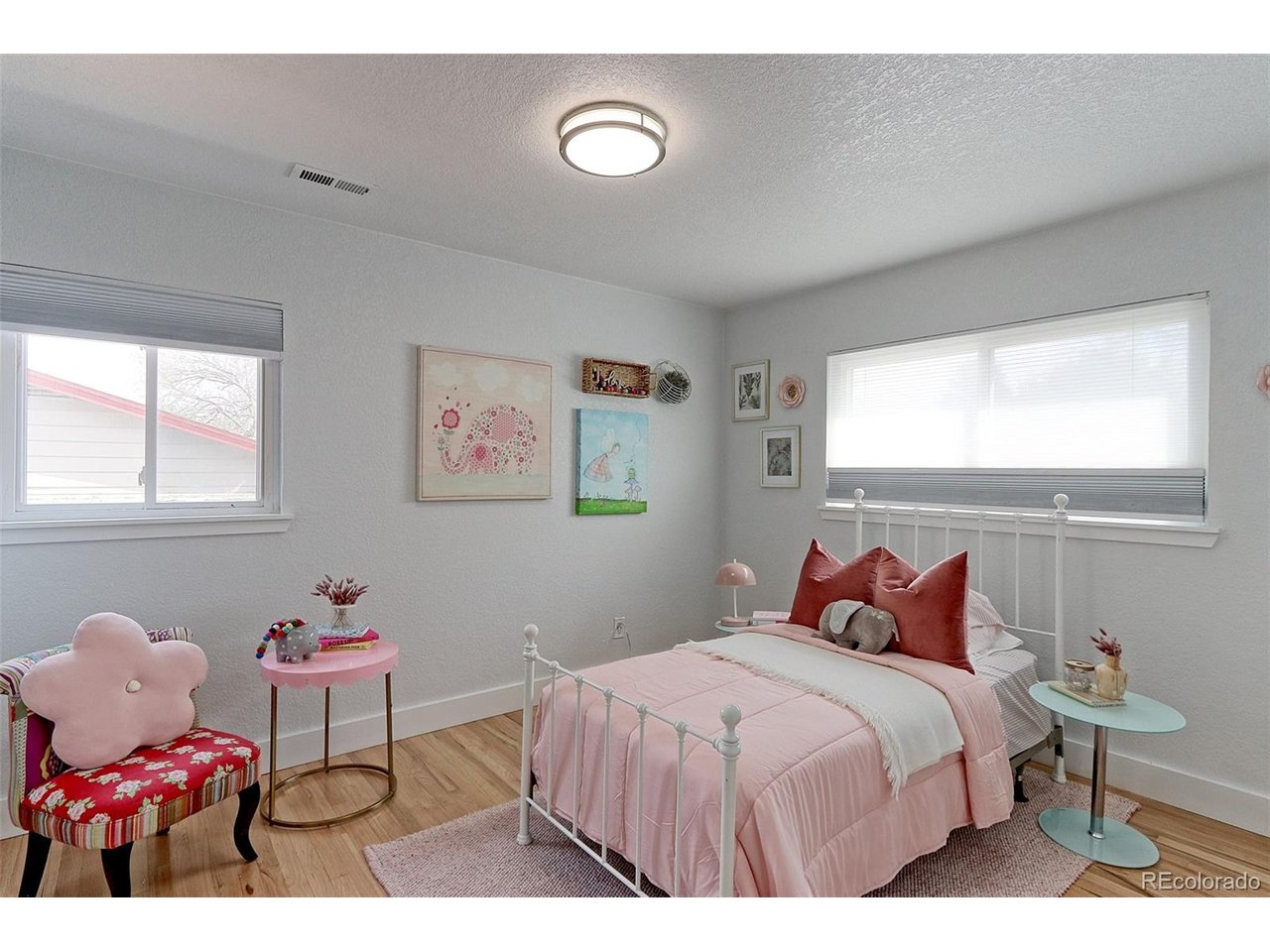This 13x10 main floor 2nd bedroom has solid Oak floors, newer thermal pane picture windows with custom cellular solar shades and designer overhead light fixture, plus a spacious closet. This room is large enough for a King bed including nightstands and dre