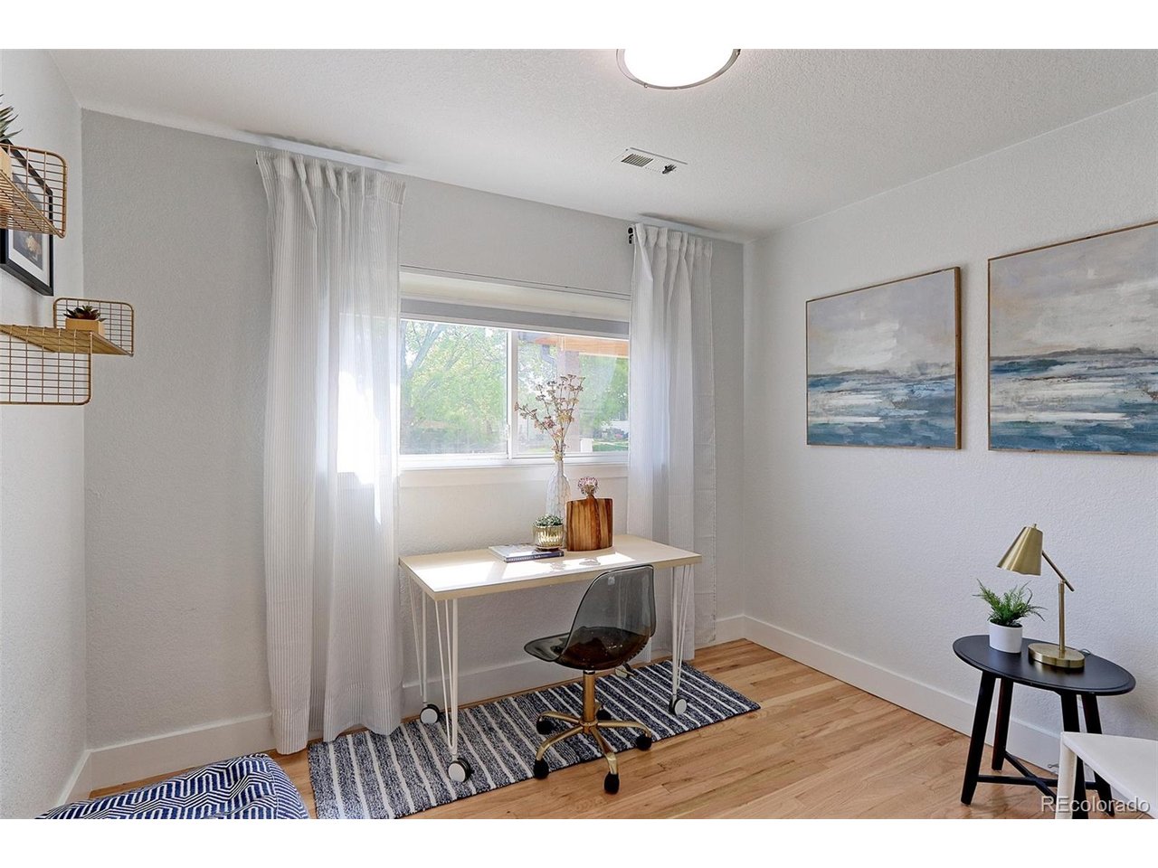 This 13x9 main floor 3rd bedroom has solid Oak floors, fresh textured and painted walls, newer thermal pane windows with custom solar shades, new overhead light fixture and spacious closet.