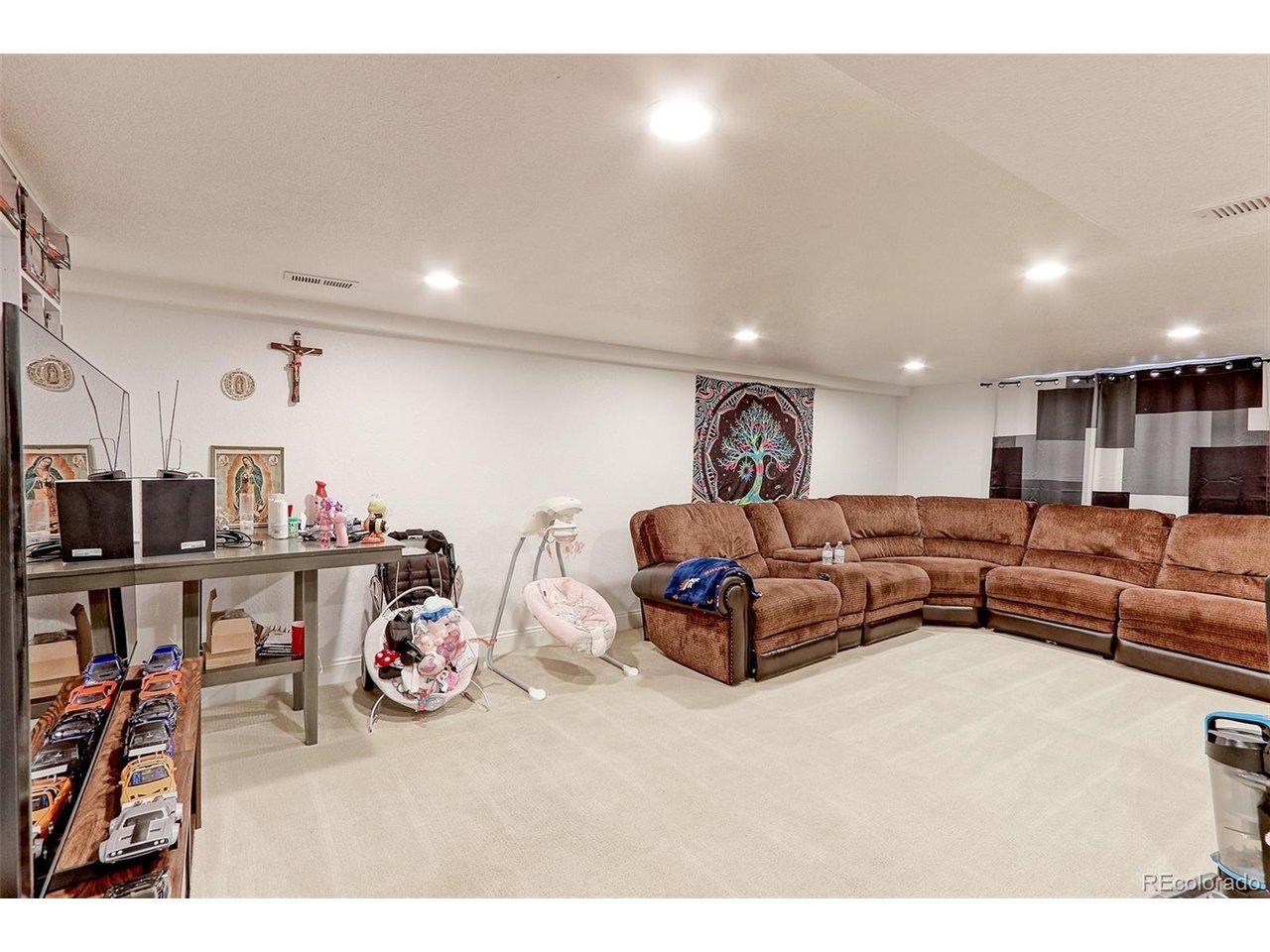This is the view of the Large family and Rec room with tons of overhead recessed LED lighting and newer hi grade carpet. The basement was built out for the Sellers parents to live with him. This is perfect for those that want to have their in-laws live wit