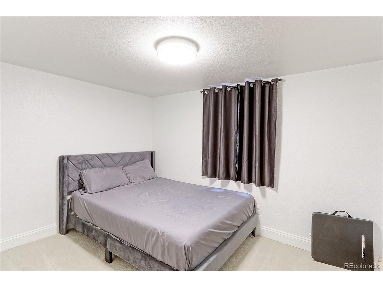This 13x11 Basement 4th bedroom with new egress window has newer carpet, newer overhead light fixture, mission style doors and spacious closet with built-in shelving.
