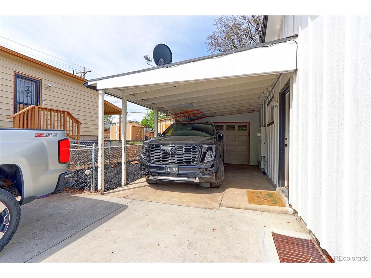 This home has an oversized attached garage plus a 21x14 covered carport with tons of off-street parking. The private door entrance to the basement apartment is shown in this photo.