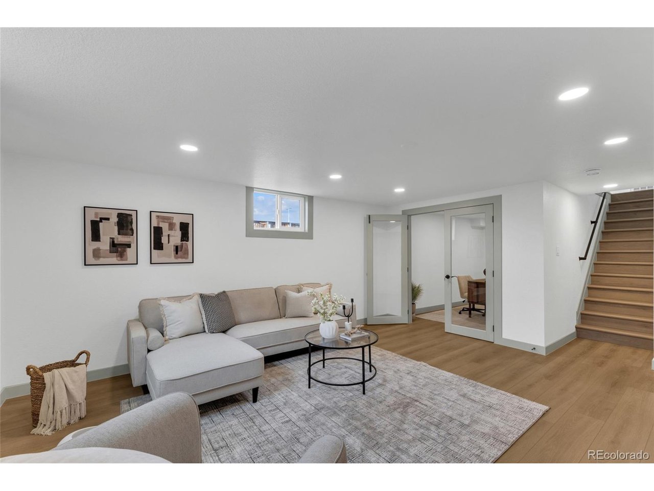 BASEMENT LIVING ROOM WITH OFFICE OFF TO THE SIDE WITH BEAUTIFUL GLASS DOORS!