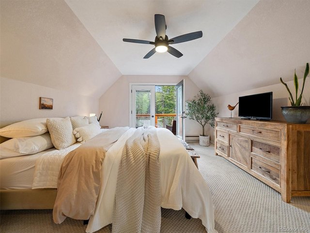 Property Photo 16 Upper-level bedroom with private balcony & forest views, ( bedroom 2 of 3) Now used as Primary